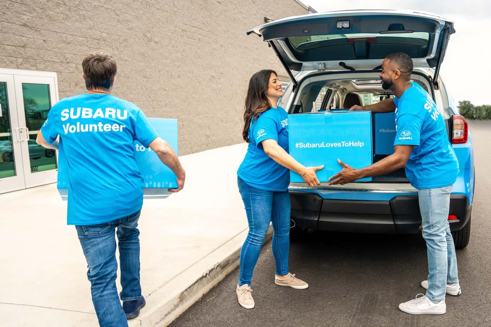 Group of Subaru Employees Handling Packages