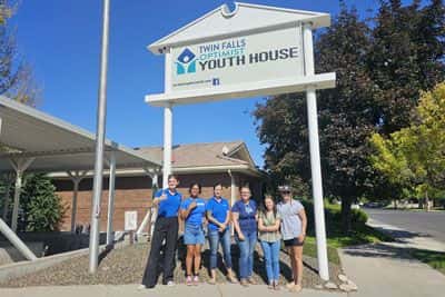 Members of the Twin Falls Subaru team with Twin Falls Optimist Youth House staff, in front of the TFOYH, after a day of volunteering.