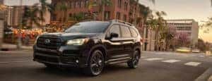 Black SUV driving down street