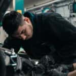 Mechanic working under the hood of a car