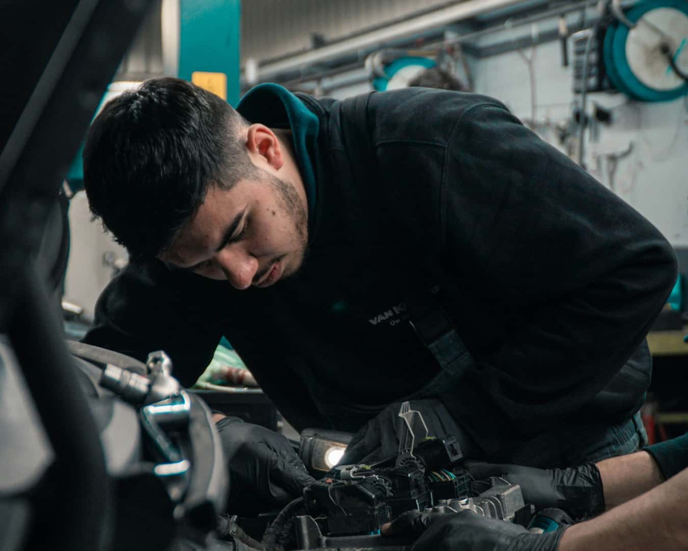 Mechanic working under the hood of a car