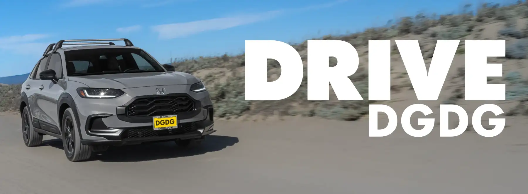 Grey Honda HR-V driving along sand dunes with 'DRIVE DGDG' hero text overlay.