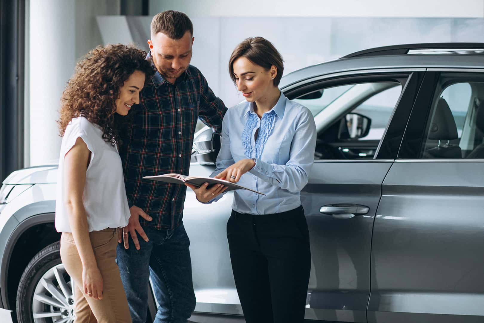 Couple speaking with a Team Chevrolet sales associate in the showroom