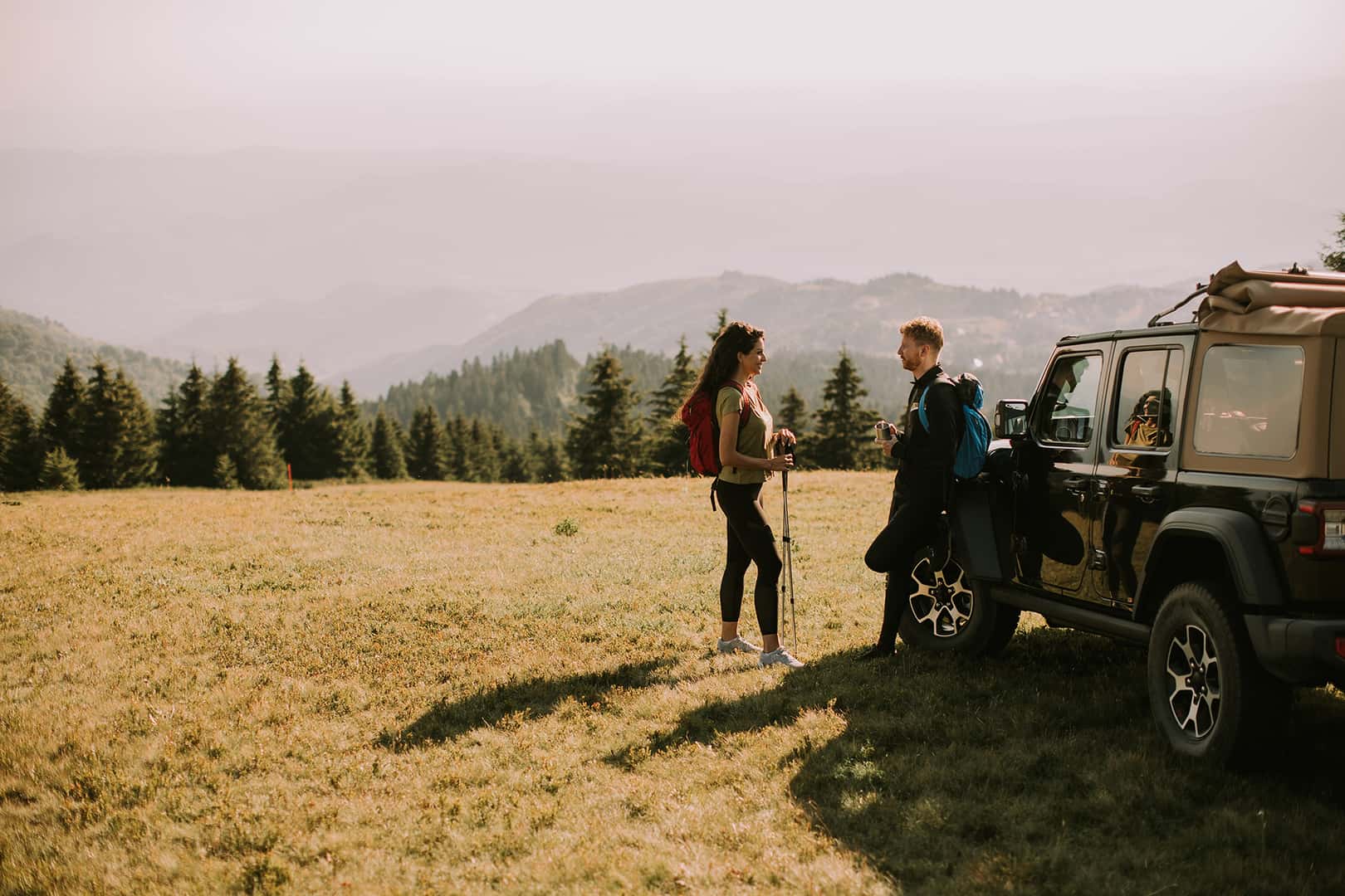 Handsome,Young,Couple,Relaxing,On,A,Terrain,Vehicle,Hood,At