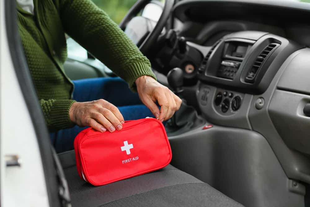 Man with First Aid kit in the car