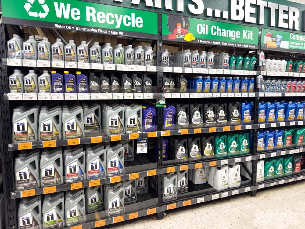 Synthetic oil vs. conventional oil bottles on store shelves