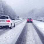 Cars and SUVs Driving on a Highway in Snow