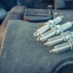 Four Spark Plugs Sitting on a Car Engine