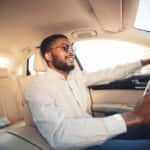 Happy Young Man Test Driving a Car