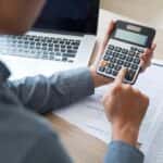 Man Calculating Car Ownership Costs