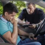 Man Getting a Ticket From a Police Officer
