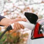 Man Plugging in an EV