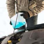 Man Pouring Anti-Freeze Into Reservoir