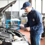 Mechanic filling out a vehicle inspection form
