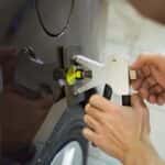 Man fixing a dent in a car fender