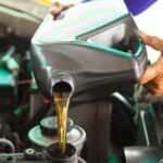 Mechanic Adding Oil to an Engine