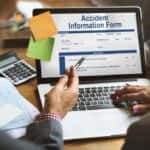 People Reviewing an Accident Report for a Used Car