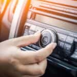 Person Increasing Volume of Car Stereo