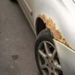 Rust covering a right fender of a used car