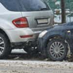 Silver gray SUV and dark blue car in an accident