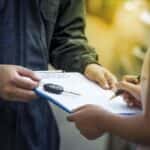 Woman signing financial form