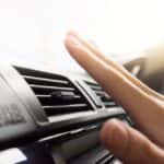 Woman's Hand on Car Air Conditioning