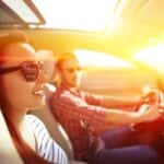 Young Couple Driving in the Summer Sunshine