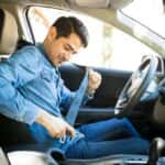 Young Man Fastening a Seatbelt
