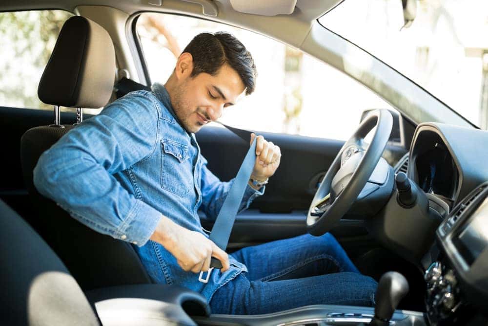 Young Man Fastening a Seatbelt