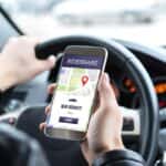 Man holding phone with a rideshare request