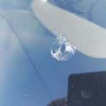 Hole in damaged windshield