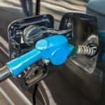 Fuel nozzle in vehicle at gas station
