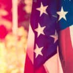 American flag against a springtime background