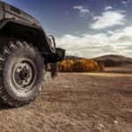 Off-road vehicle view of a tire in a dry wilderness