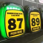Yellow and black octane rating buttons at a gas station