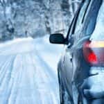 Car driving on snow-covered road