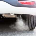 exhaust pipe on car emitting carbon dioxide and greenhouse gases