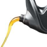 engine oil pouring from black plastic container