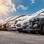 Lineup of new vehicles parked on a car lot