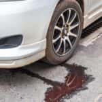 White car leaking radiator fluid underneath