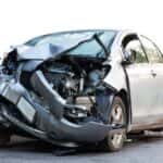 Totaled car with its front end smashed in