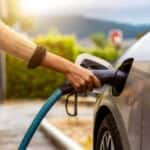 Woman plugging in her EV at an EV charging station