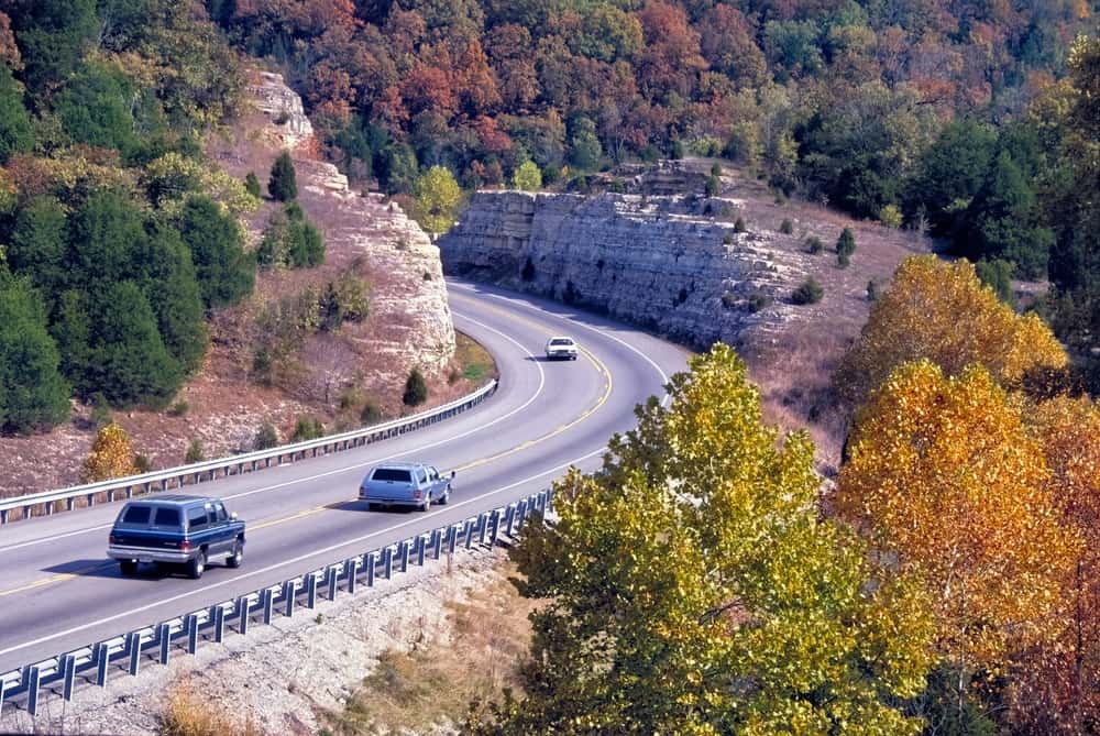 Cars on a fall road trip in the Ozarks