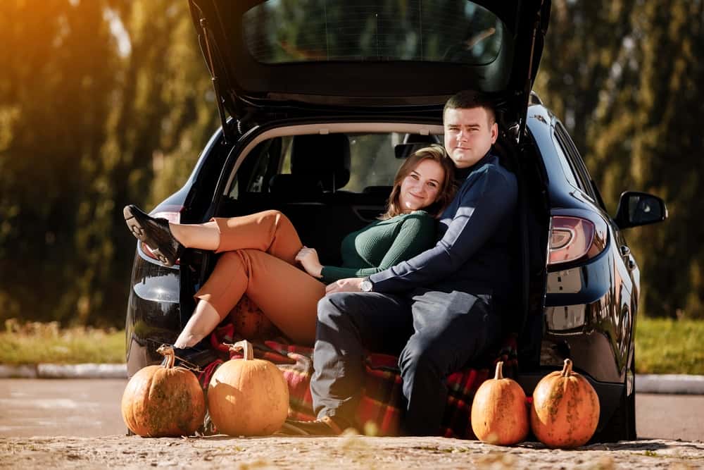 Couple in the back of a car before a road trip