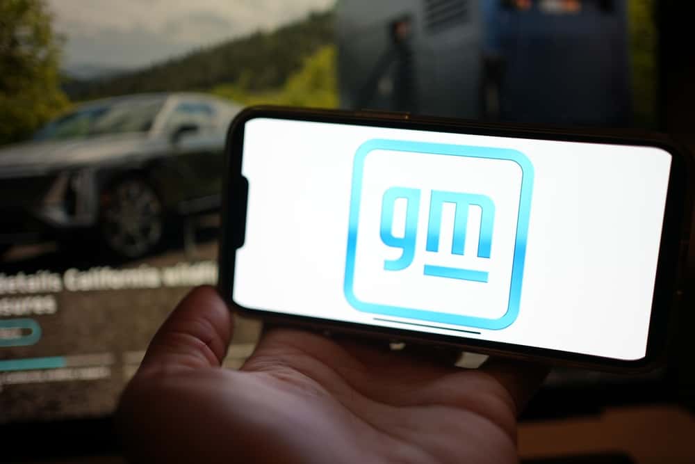 GM logo on a smartphone inside a vehicle