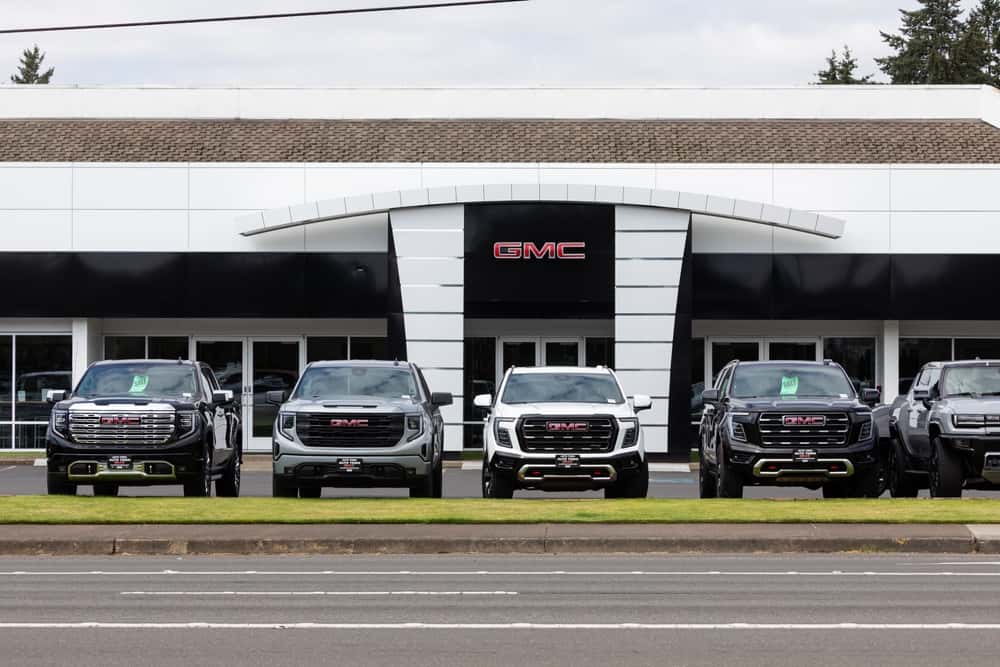 GMC vehicles in front of a dealership