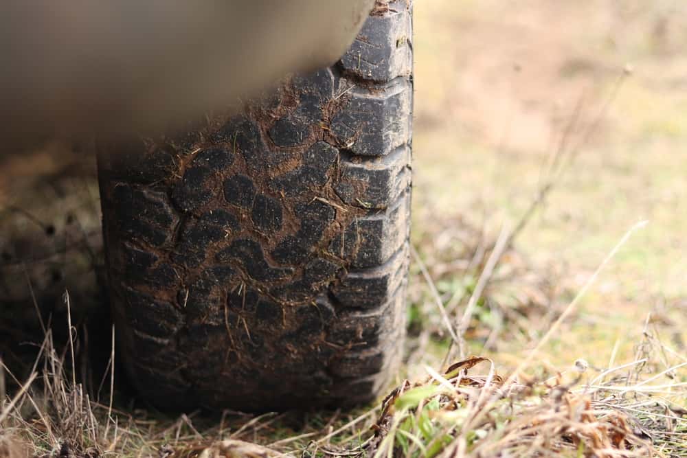 Close-up of mud on the tires of a used truck