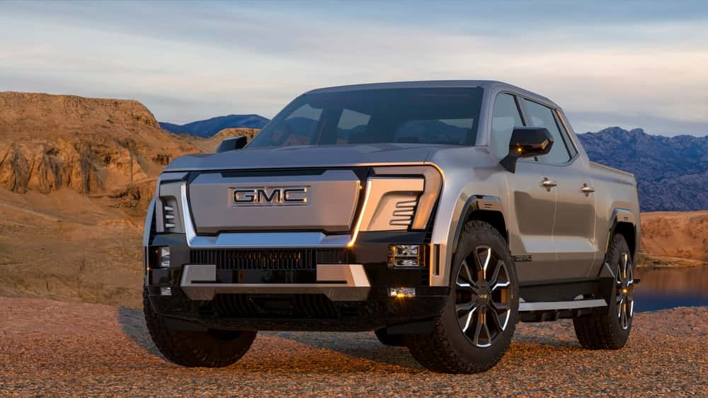 A GMC Sierra EV against a desert backdrop
