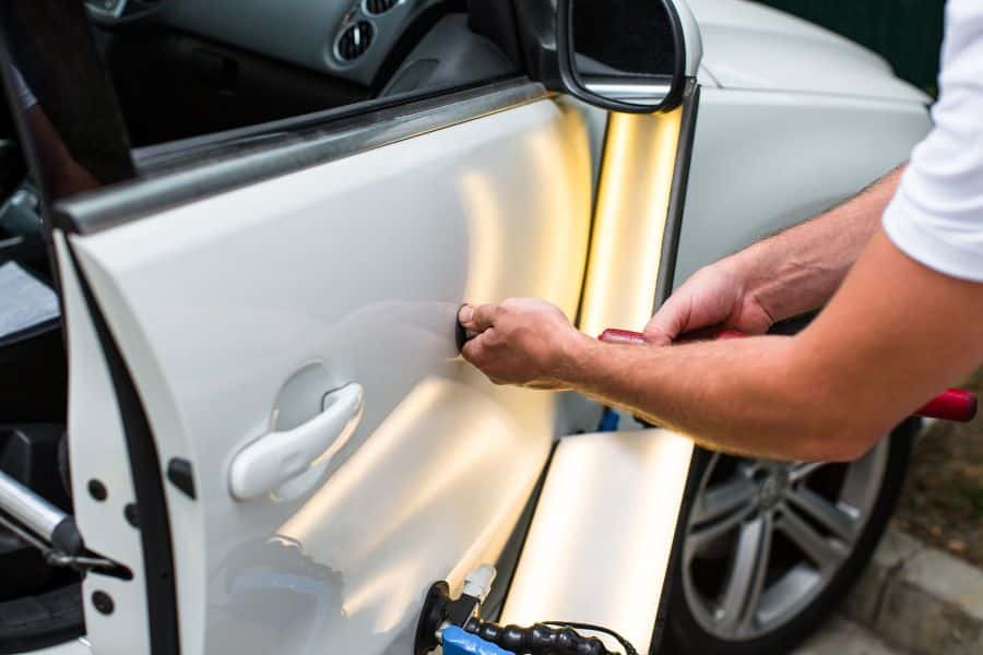 technician repairing a car from accident