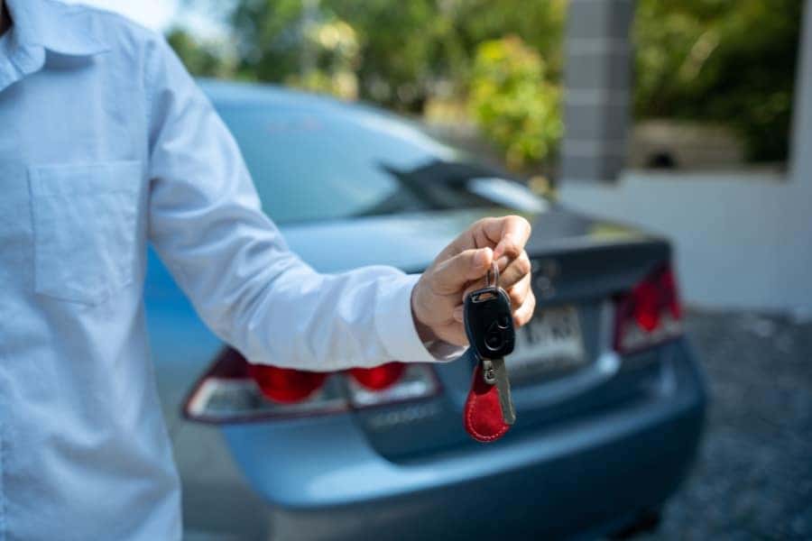 person giving a car key